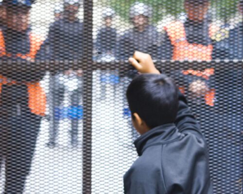 A young boy outside the British Embassy checks out the police presence